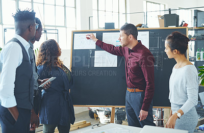 Buy stock photo Shot of a group of businesspeople discussing statistics