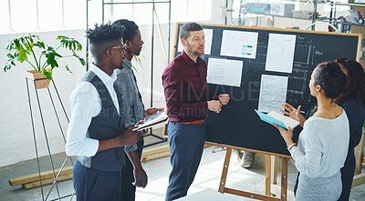 Buy stock photo Shot of a group of businesspeople discussing statistics