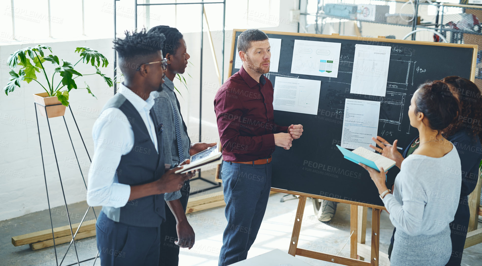 Buy stock photo Shot of a group of businesspeople discussing statistics