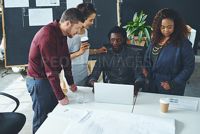 Buy stock photo Shot of a group of coworkers discussing something on a laptop during a meeting