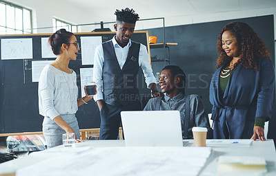 Buy stock photo Shot of a group of coworkers discussing something on a laptop during a meeting