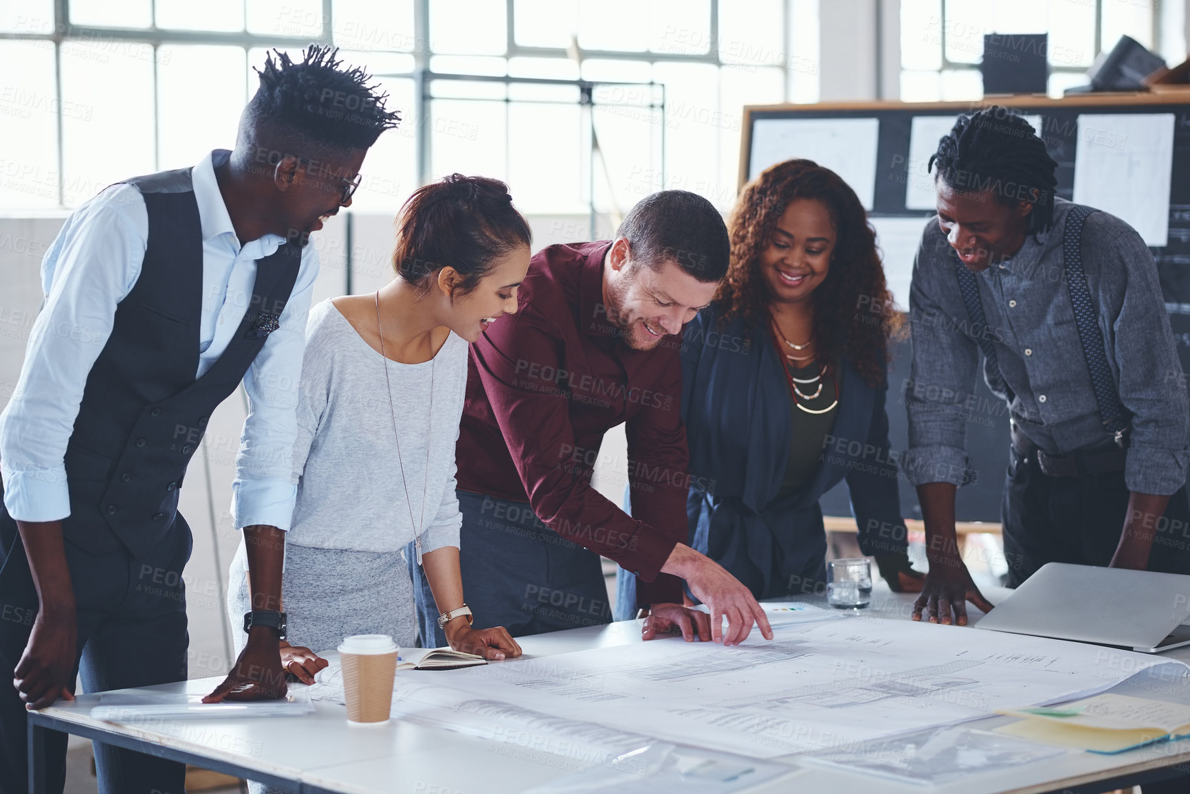 Buy stock photo Cropped shot of a team of professionals working on blueprints in an office