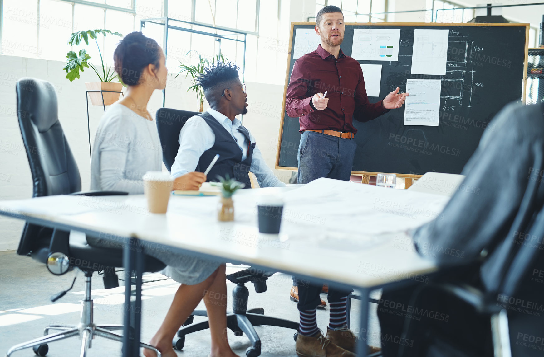 Buy stock photo Cropped shot of a young creative businessman doing a presentation in the office