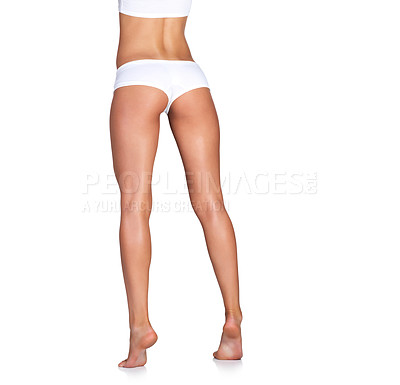 Buy stock photo Studio shot of an unrecognizable young woman in her underwear posing against a white background