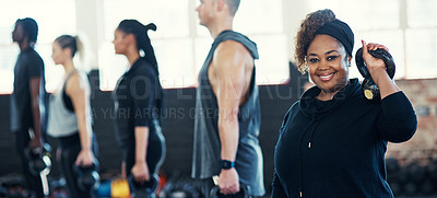 Buy stock photo Shot of a cheerful group of young people standing in a row and training with weights while one looks into the camera in a gym
