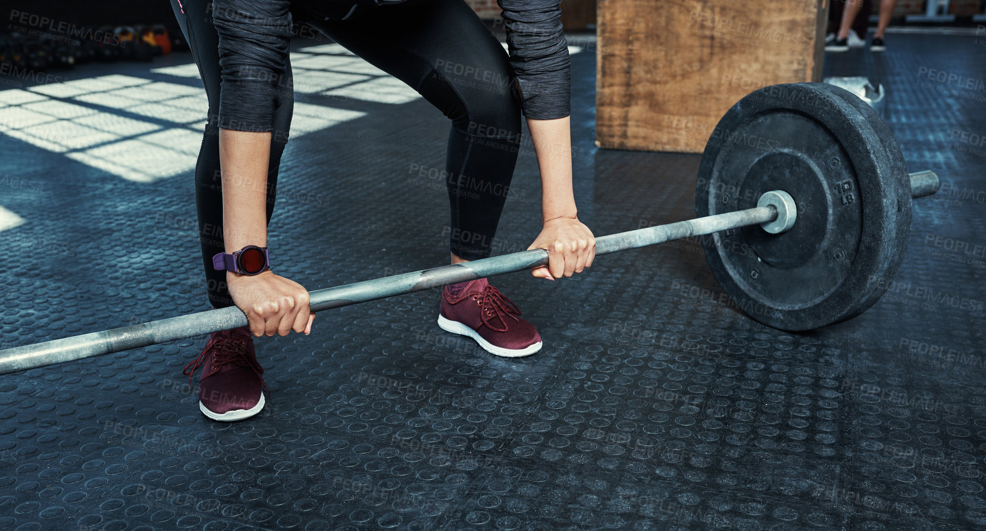Buy stock photo Shot of an unrecognizable woman lifting weights in a gym