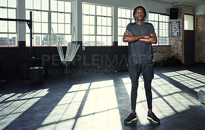 Buy stock photo Shot of a young man in a gym