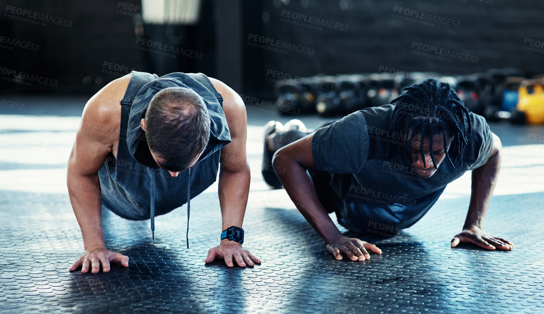 Buy stock photo Shot of young men doing push ups in a gym