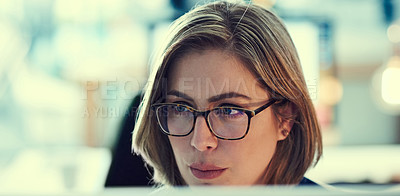 Buy stock photo Shot of a young businesswoman working late in an office