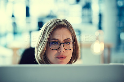 Buy stock photo Shot of a young businesswoman working late in an office