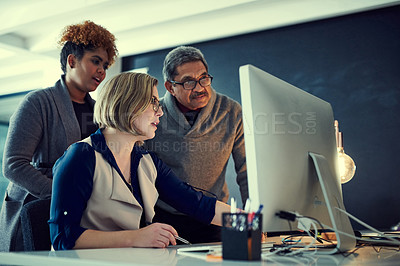 Buy stock photo Shot of a group of businesspeople working late in an office