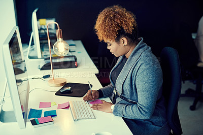 Buy stock photo Shot of a young businesswoman working late in an office