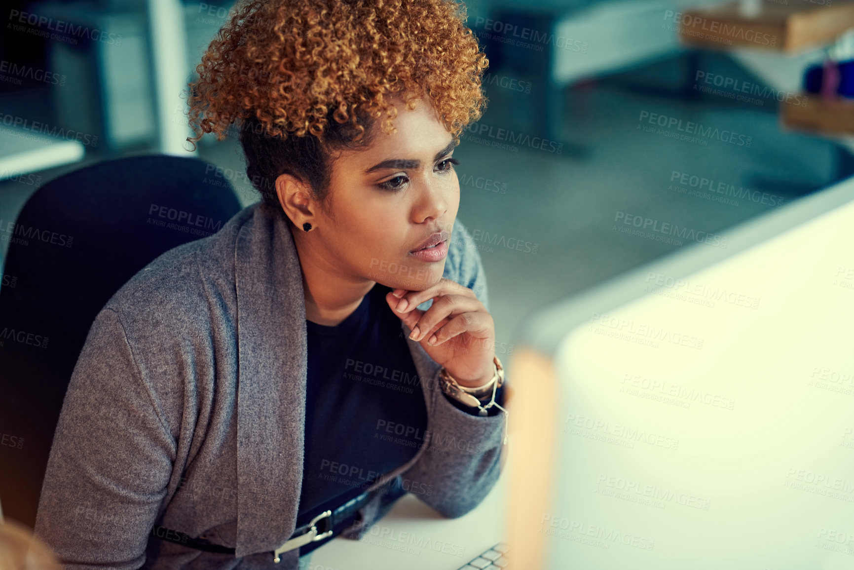 Buy stock photo Shot of a young businesswoman working late in an office