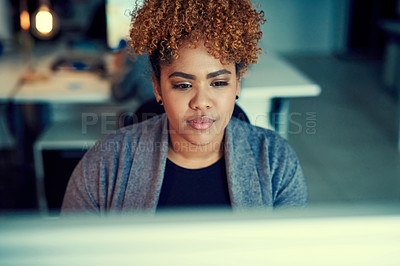 Buy stock photo Shot of a young businesswoman working late in an office