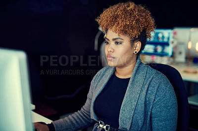 Buy stock photo Shot of a young businesswoman working late in an office