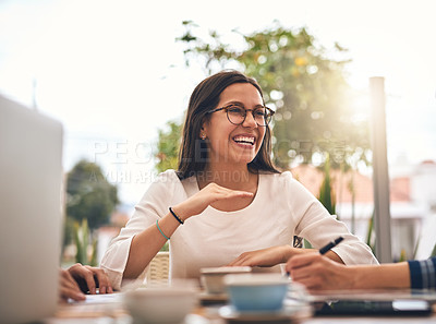 Buy stock photo Shot of a cheerful young creative businesswoman having a discussion with coworkers at a meeting around a table in a coffeeshop