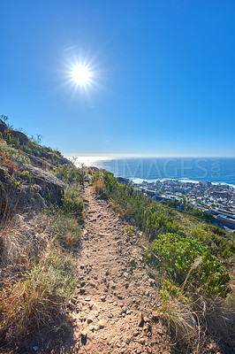 Buy stock photo Remote mountain hiking trail on table mountain on a sunny day. Mountainous walking path high above a coastal city in South Africa against a blue horizon. Popular tourist attraction in Cape Town