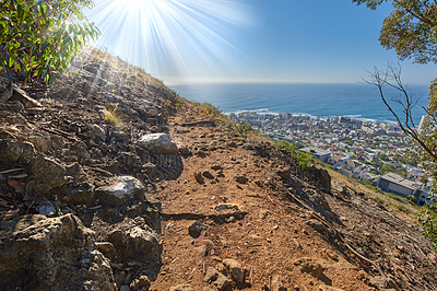 Buy stock photo Remote mountain hiking trail on Table Mountain. Mountainous walking path surrounded by bushes and trees. Pathway on a mountaintop. Popular tourist attraction in Cape Town. Walking trails to explore