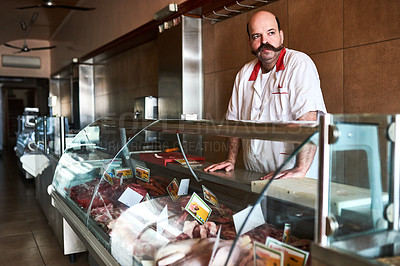 Buy stock photo Shot of a butcher at his store