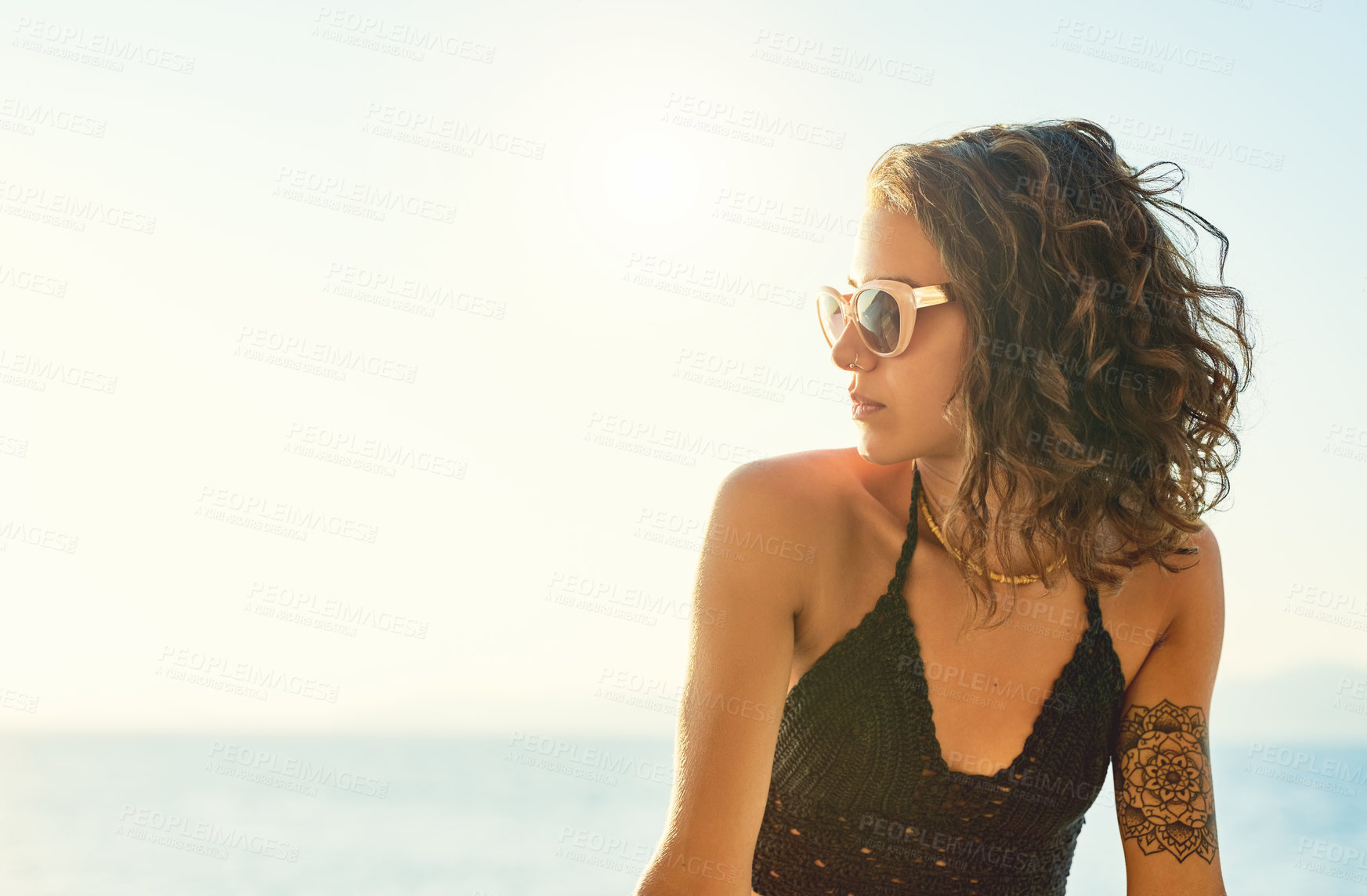 Buy stock photo Woman, sunglasses and sunset at beach with thinking, reflection and mock up space on vacation. Girl, person and blue sky by ocean for break in nature with memory, profile or ideas on holiday in Spain