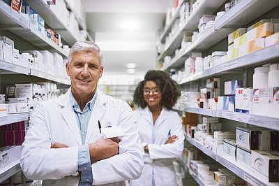 Buy stock photo Portrait of two cheerful and confident pharmacist standing with arms folded while looking into the camera in a pharmacy