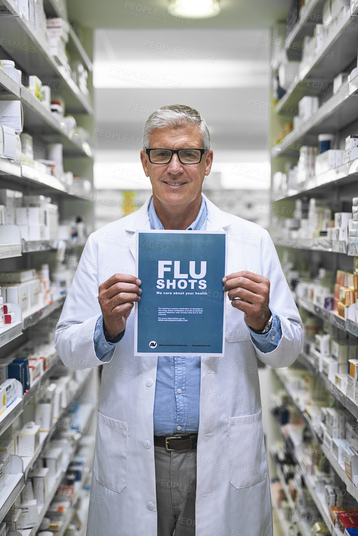Buy stock photo Portrait of a mature male pharmacist holding up a sign indicating that you can get flu shots there