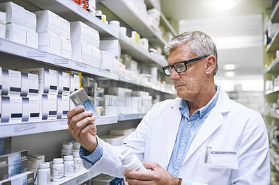 Buy stock photo Pharmacy, medicine and search with man in store for label reading, inspection and inventory. Medical, healthcare and pills with mature male pharmacist in clinic for expert, wellness and product check
