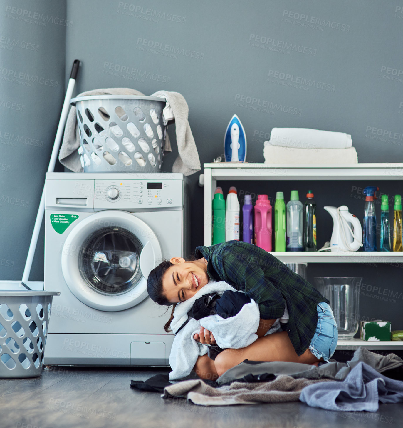 Buy stock photo Full length portrait of an attractive young woman clutching a pile of freshly washed laundry