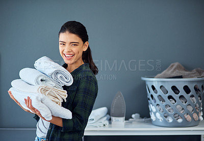 Buy stock photo Laundry, pile and woman with towel, portrait and spring cleaning in weekend, linen and routine in house. Housework, washing and person with chores, responsibility and folded in home, proud or hygiene