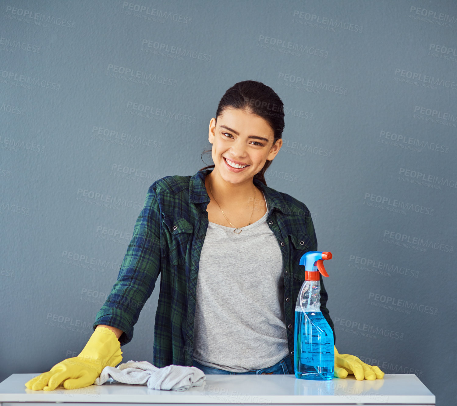Buy stock photo Studio portrait of an attractive young woman doing some spring cleaning