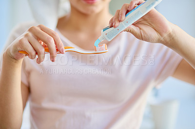 Buy stock photo Cropped shot of an unrecognizable young woman brushing her teeth in the bathroom at home