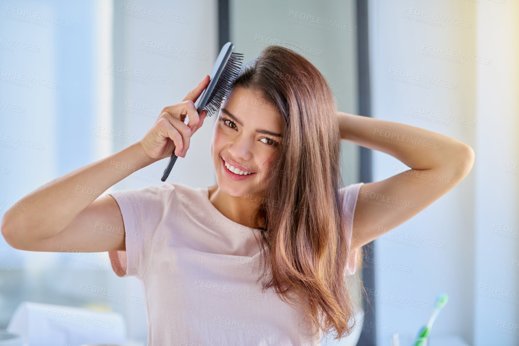 Buy stock photo Woman, portrait and brushing hair in home, grooming and morning for getting ready in bathroom. Female person, cosmetics tool and hairbrush for hairstyle, Indonesia and treatment for healthy growth