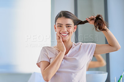 Buy stock photo Cropped portrait of a beautiful young woman stretching her gar out in the bathroom at home