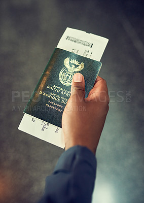 Buy stock photo Shot of an unrecognizable person holding a passport indoors