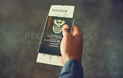 Buy stock photo Shot of an unrecognizable person holding a passport indoors 