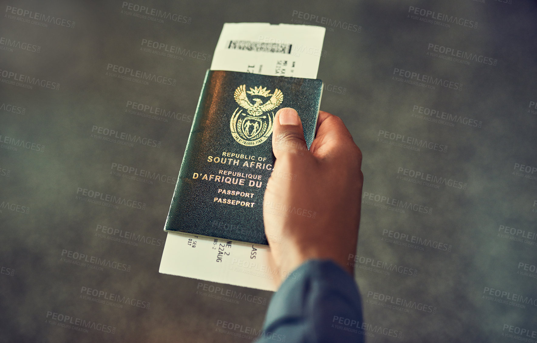 Buy stock photo Shot of an unrecognizable person holding a passport indoors 