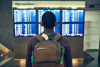Buy stock photo Shot of a man checking the flight times in an airport