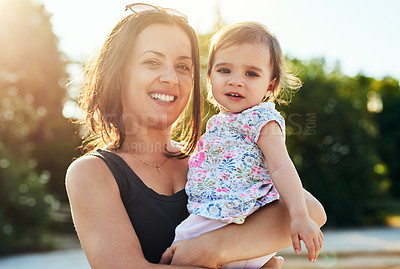 Buy stock photo Shot of a young mother and her little girl outdoors