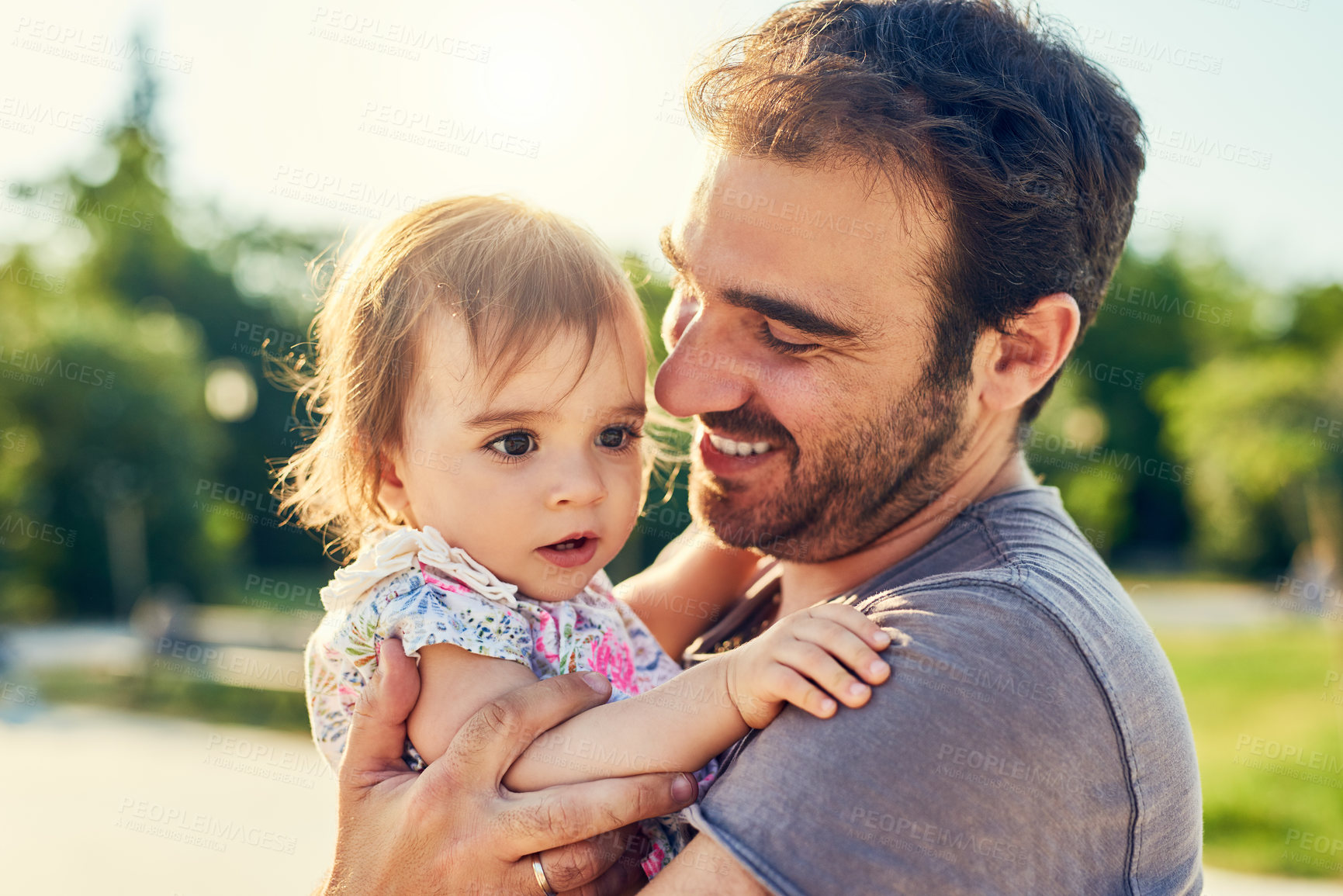 Buy stock photo Shot of a young father with his little girl outdoors