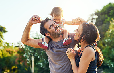 Buy stock photo Family, dad and daughter on shoulders in park with mom, happiness or love in summer sunshine. Young couple, baby girl or laugh together for freedom, bond or holding hands for care, backyard or garden