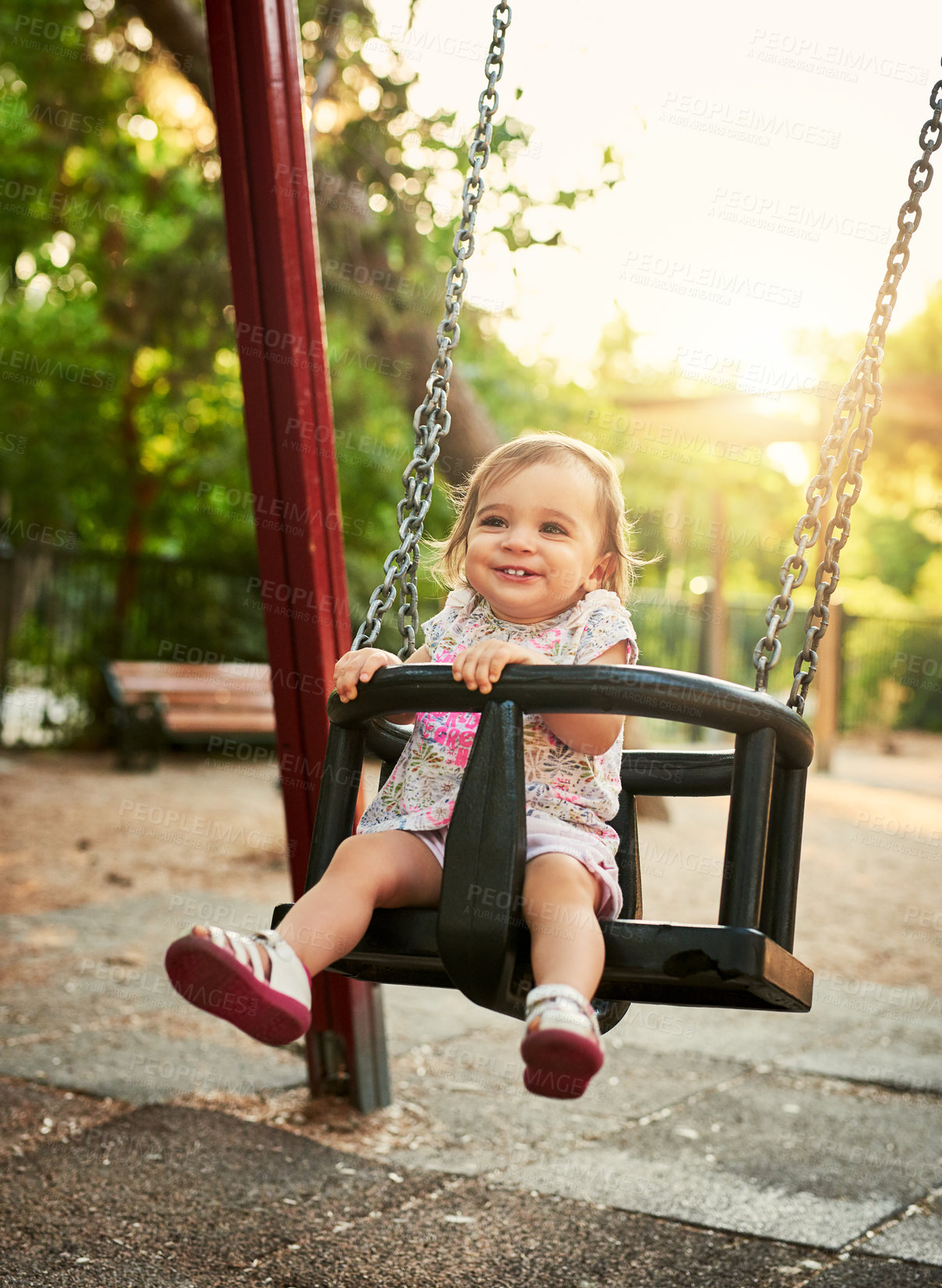 Buy stock photo Girl, baby and happy in swing at park, garden and outdoor with fun, learning and balance on vacation in summer. Child, toddler and playful with smile for development, growth and sunshine on holiday