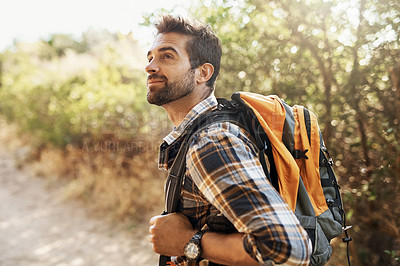 Buy stock photo Cropped shot of a handsome young man hiking in the mountains