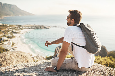 Buy stock photo Full length shot of an unrecognizable young man taking in the views while hiking in the mountains
