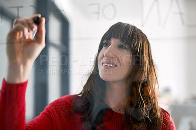 Buy stock photo Shot of businesspeople writing on a glass wall in the office 
