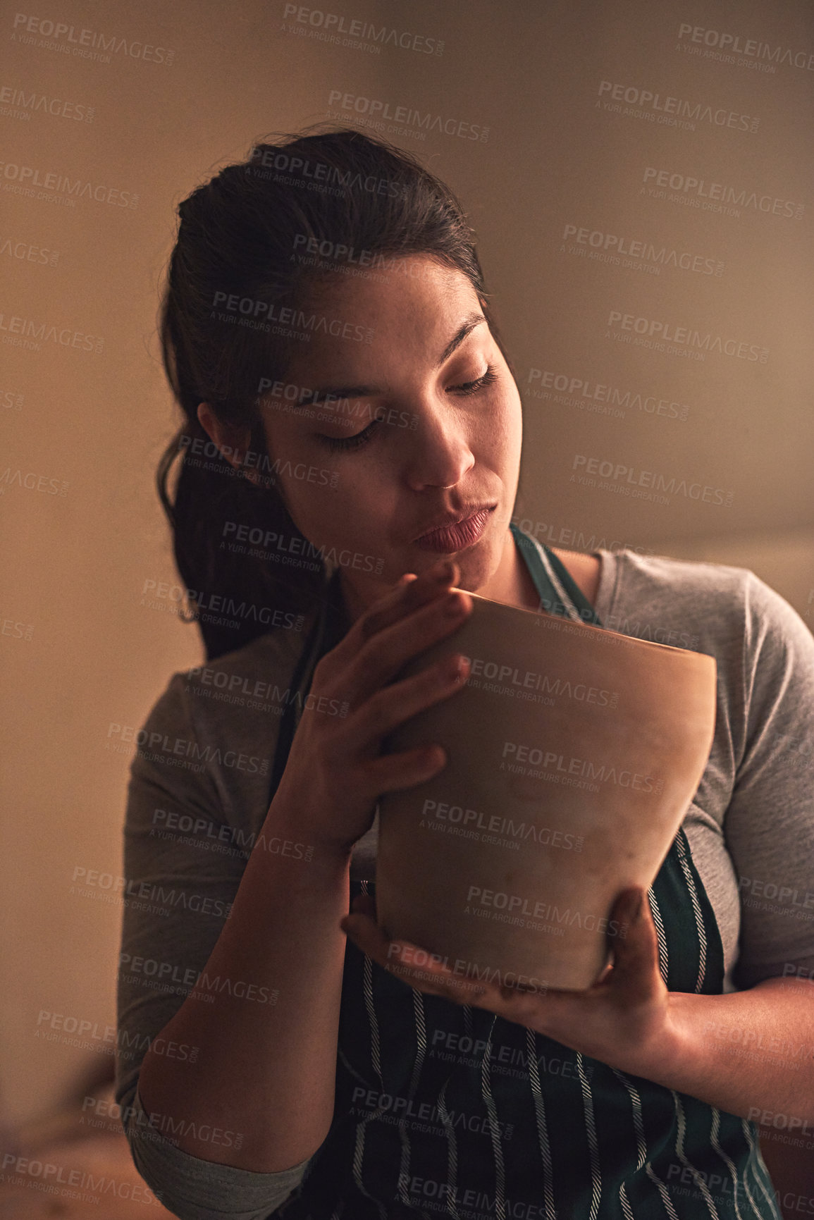 Buy stock photo Shot of a ceramic artist working on her pottery in a workshop