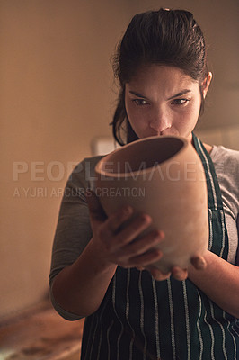 Buy stock photo Shot of a ceramic artist working on her pottery in a workshop