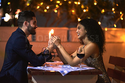 Buy stock photo Love, couple and dinner date, happiness and celebrate relationship, anniversary and Valentines day. Romance, man and woman at restaurant, candles and wine for quality time, smile and holding hands