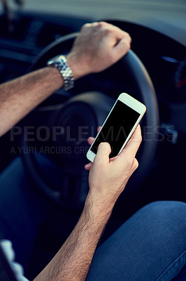 Buy stock photo Cropped shot of a unrecognizable man using his phone while driving to a destination
