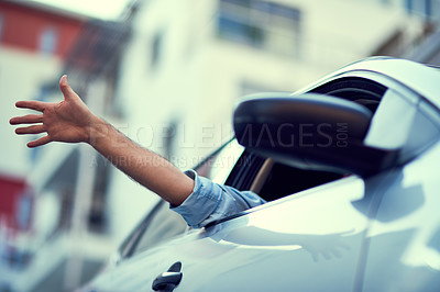 Buy stock photo Shot of a unrecognizable person driving in their car while sticking their hand out of the window