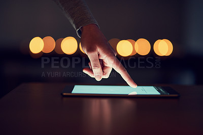 Buy stock photo Closeup of a unrecognizable person's hand browsing the internet on a digital tablet at night